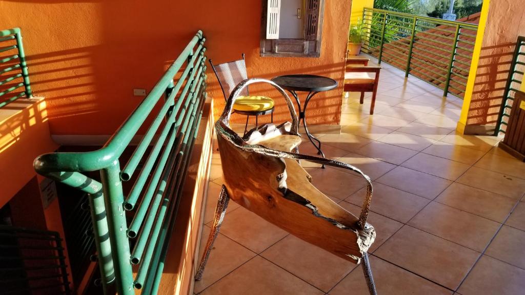 a dog sitting in a bench on a balcony at Altamont West Hotel in Montego Bay