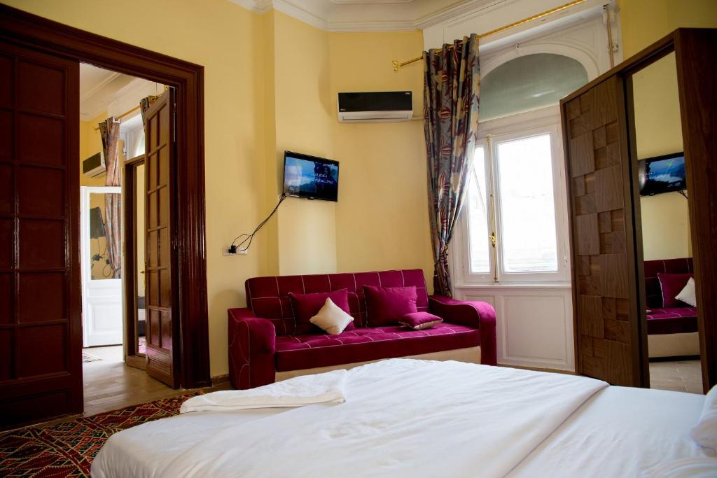 Postel nebo postele na pokoji v ubytování New Grand Royal Hotel Cairo