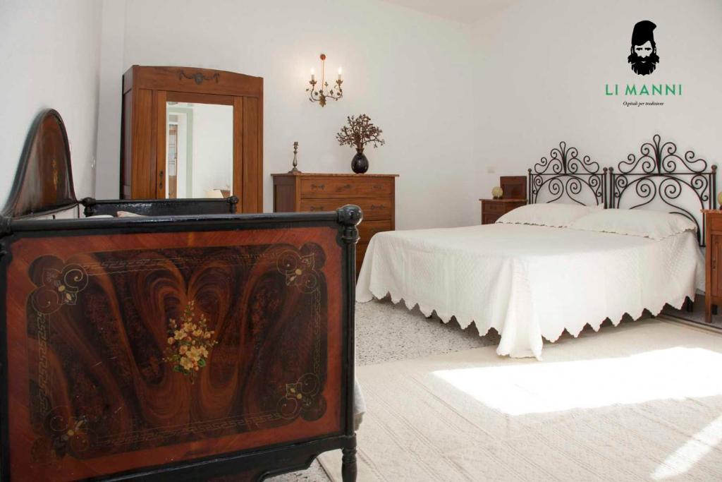 Postel nebo postele na pokoji v ubytování Locanda Li Manni