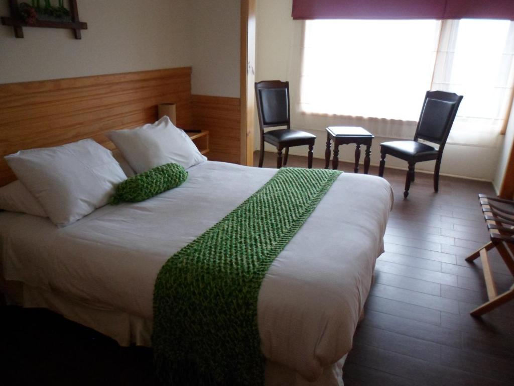Postel nebo postele na pokoji v ubytování Dein Haus Hotel y Departamentos