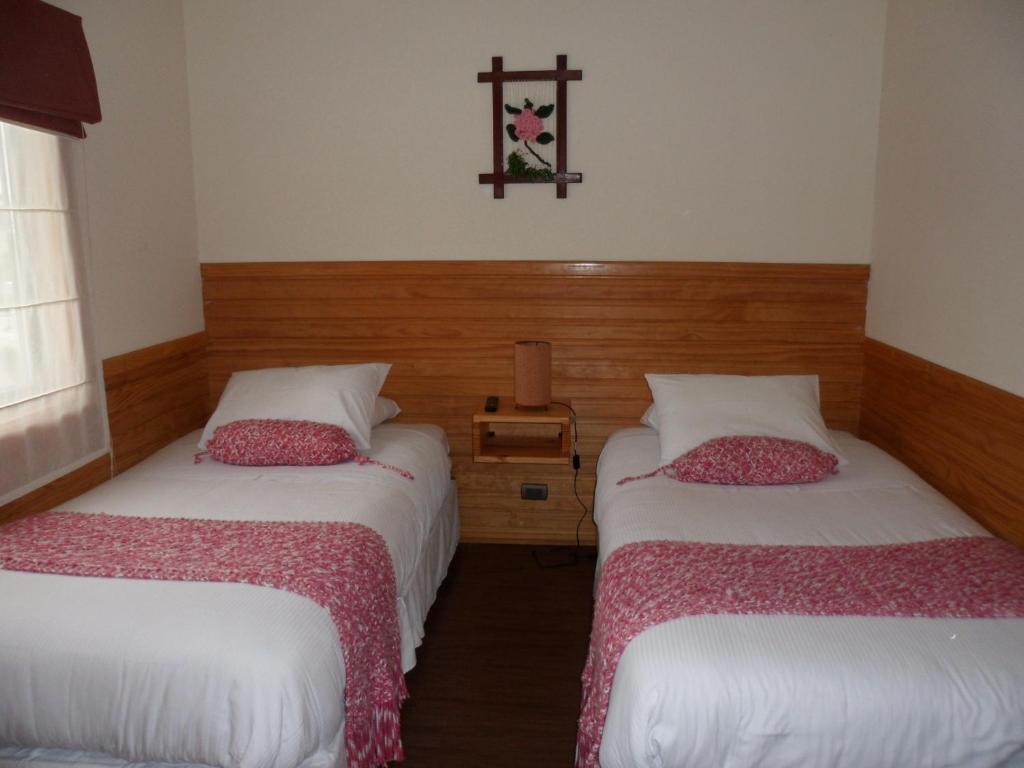 Postel nebo postele na pokoji v ubytování Dein Haus Hotel y Departamentos