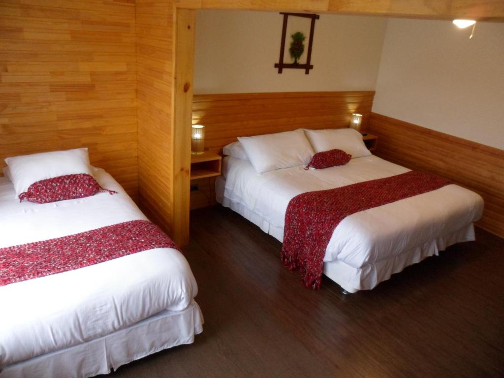 Postel nebo postele na pokoji v ubytování Dein Haus Hotel y Departamentos