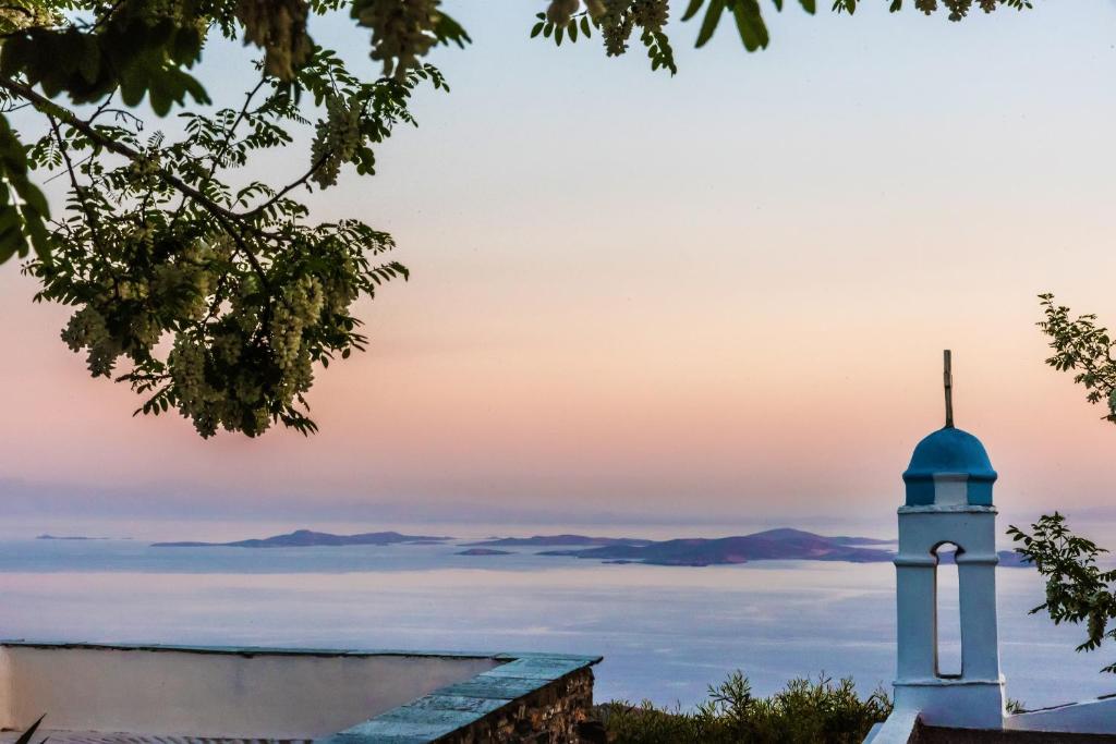 a lighthouse in the middle of a sea of clouds at Villa Ghisi in Arnados