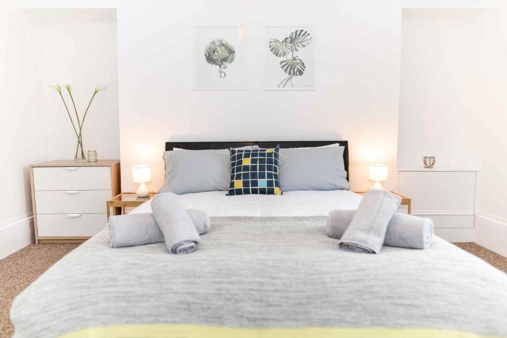 a bedroom with a large bed with two lamps on it at Stafford Modern Apartment in Aberdeen