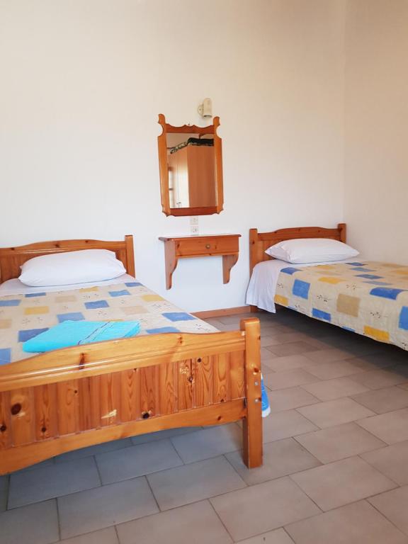 Postel nebo postele na pokoji v ubytování Asimina's House