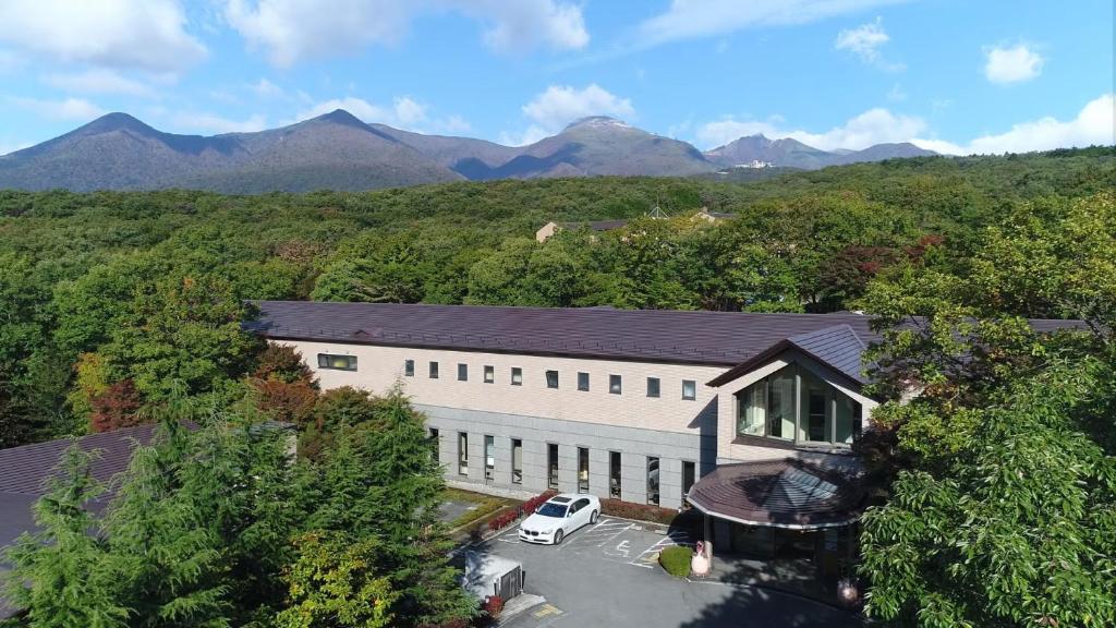 an aerial view of a building with a van parked in front at Blancvert Nasu Onsen Hotel in Nasu