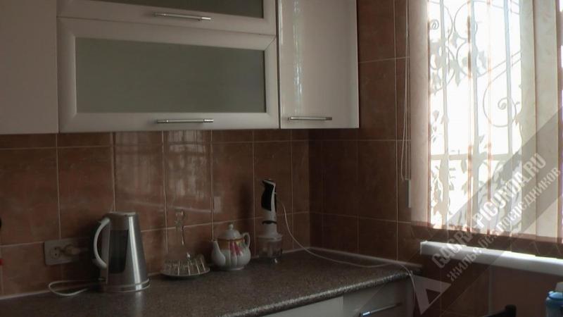 a kitchen counter with a sink and a window at Однокомнатная квартира у моря in Gagra