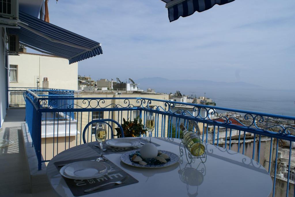 a table on a balcony with a view of the ocean at Island Apartment in Kavála