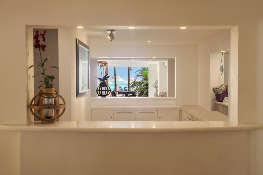 a large white kitchen with a large mirror at Sugar Bay Barbados - All Inclusive in Bridgetown