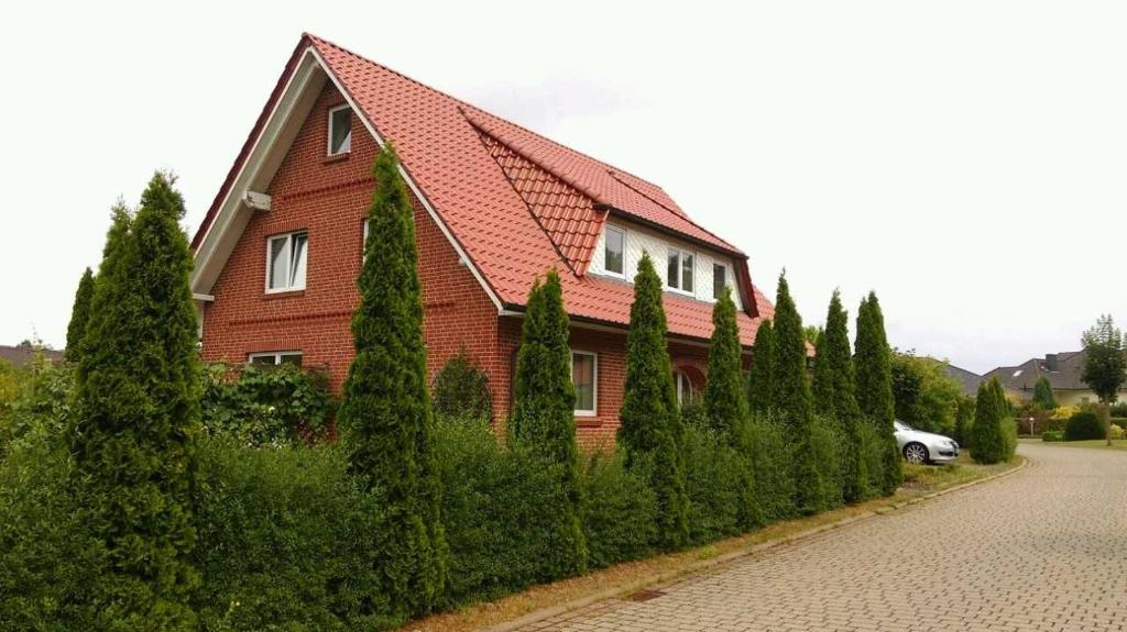 a house with a bunch of trees in front of it at Ferienwohnung Jannsen in Bad Bevensen