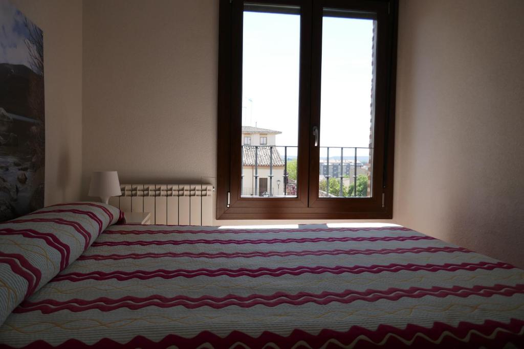 Postel nebo postele na pokoji v ubytování Apartamentos La Muralla