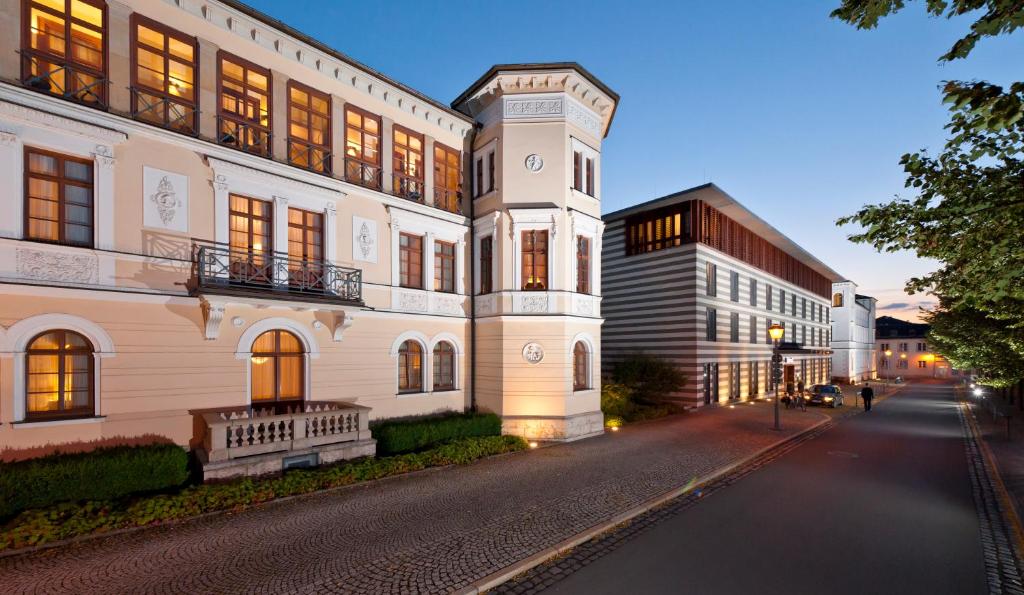a large white building on a city street at night at Dorint Am Goethepark Weimar in Weimar
