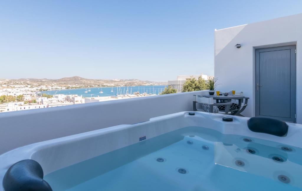 a bath tub with a view of the ocean at Uncle's Luxury Jacuzzi in Adamantas