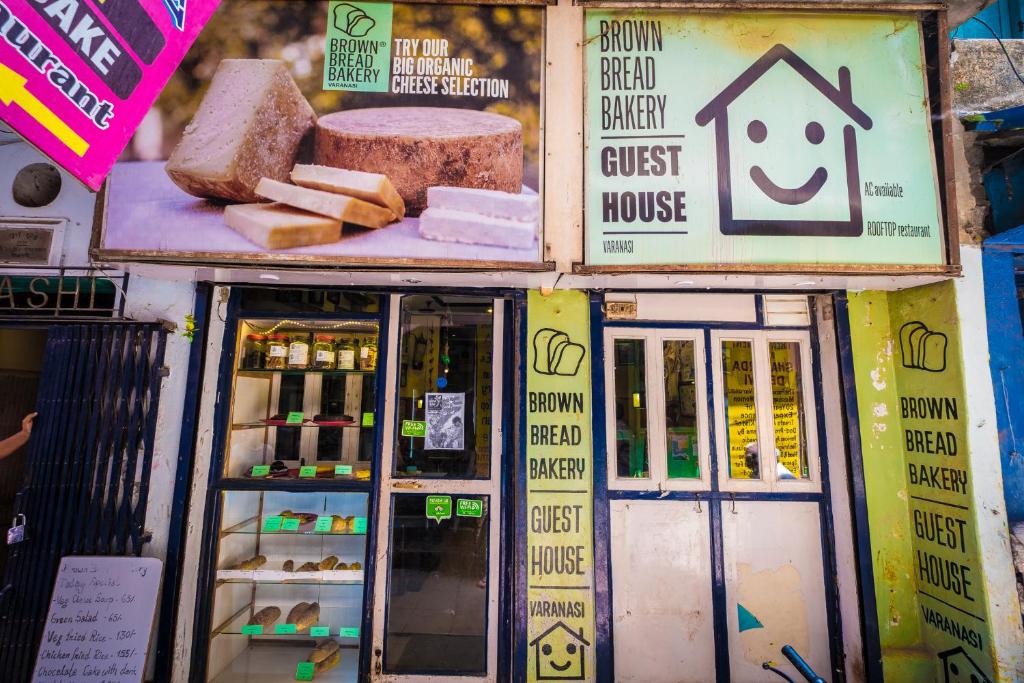 a food truck with cheese and bread in a store at Brown Bread Bakery Guest House in Varanasi