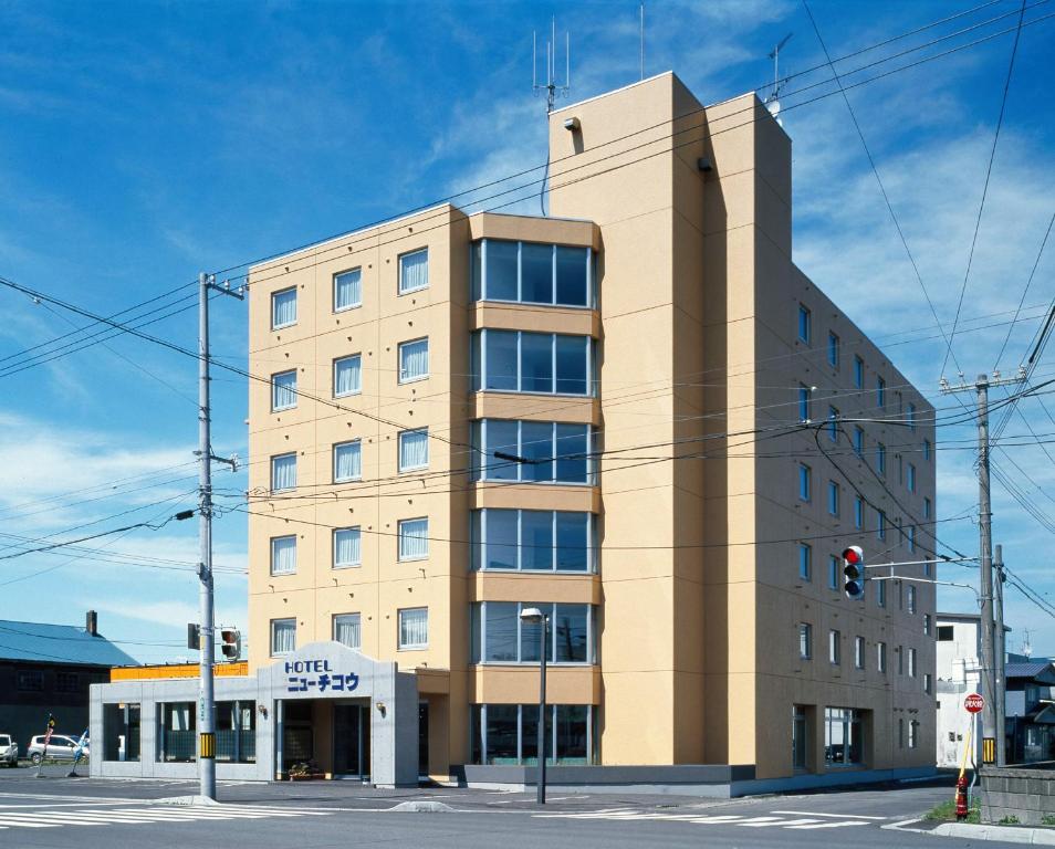 a large building with a clock on the side of it at Hotel New Chikou in Wakkanai