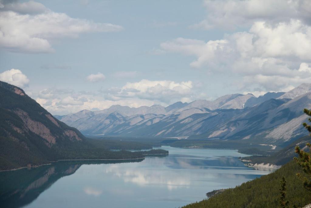 a view of a lake in the middle of mountains at Double G Service in Muncho Lake