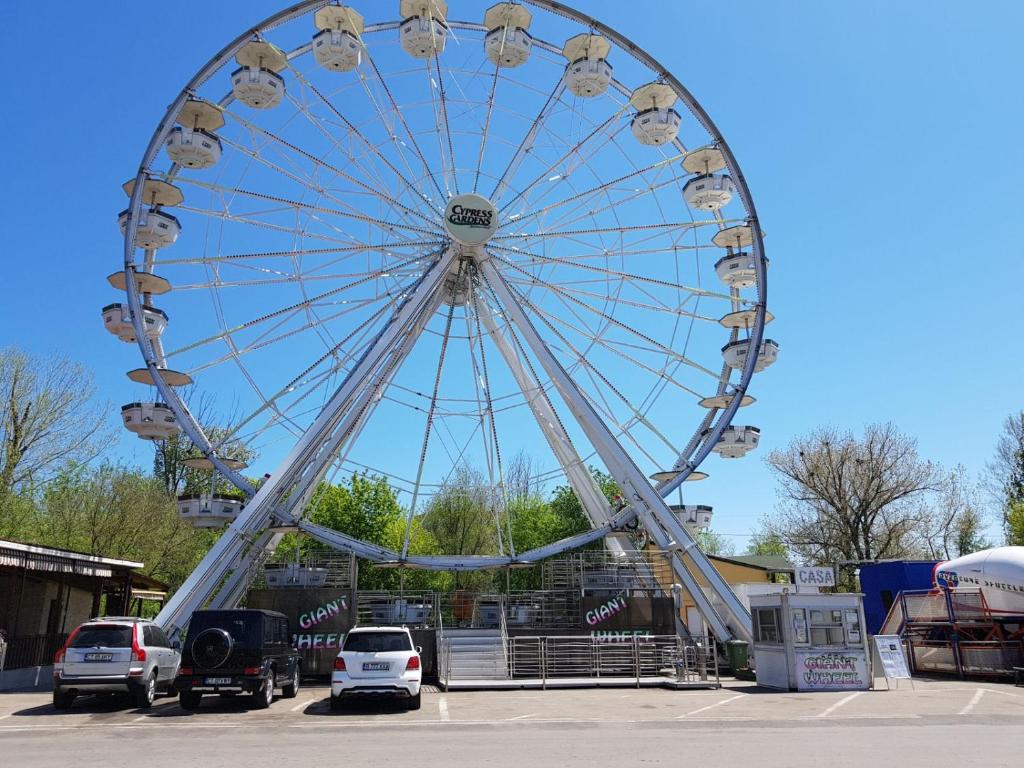 a large ferris wheel in a parking lot at Coralia Luna Park Apartments in Mamaia