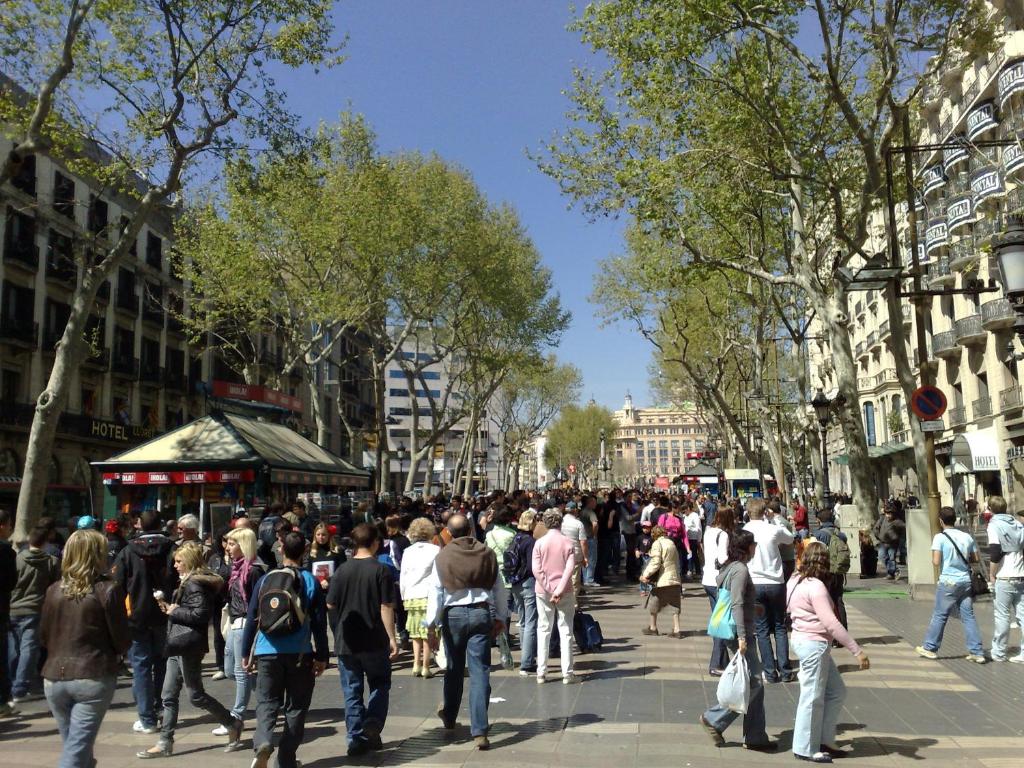 a crowd of people walking down a busy city street at Hotel Toledano Ramblas in Barcelona