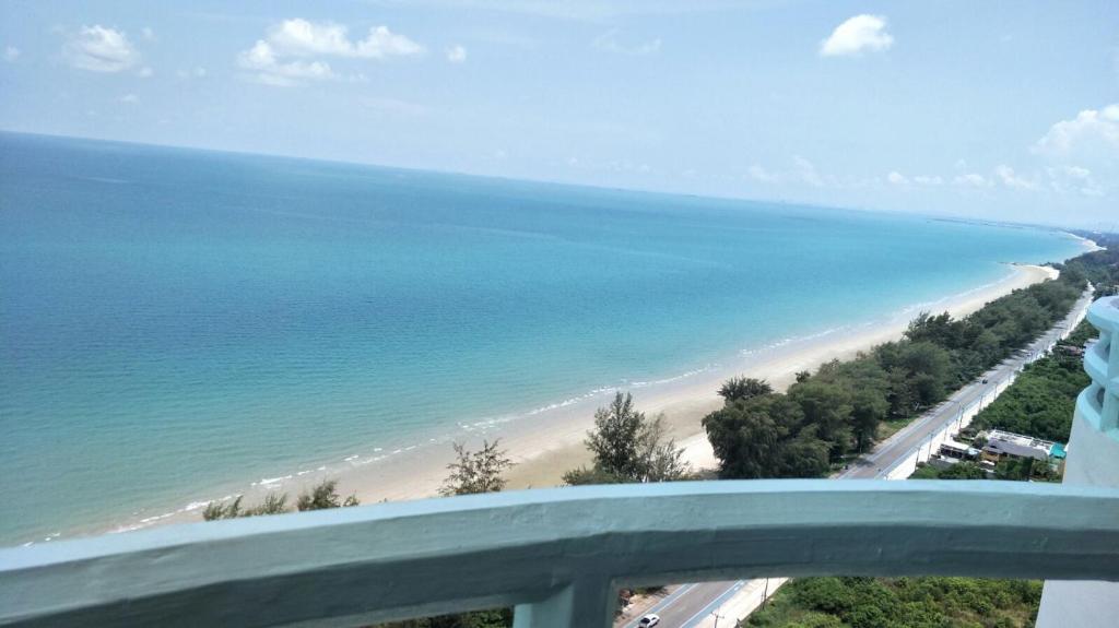 a view of a beach from a balcony at VIP Condochain Rayong in Ban Phe