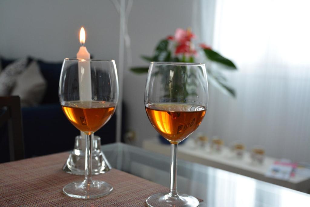 dos copas de vino sentadas en una mesa con una vela en Tabaibita, en Orzola