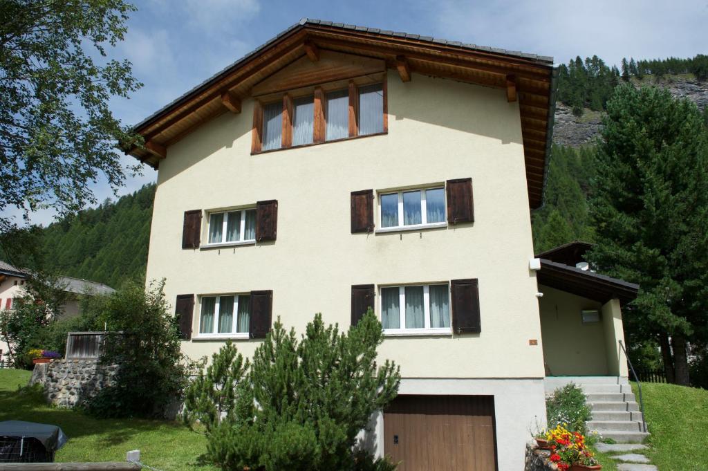 une maison dans les montagnes avec un garage dans l'établissement Ferienhaus Wanner, à Splügen