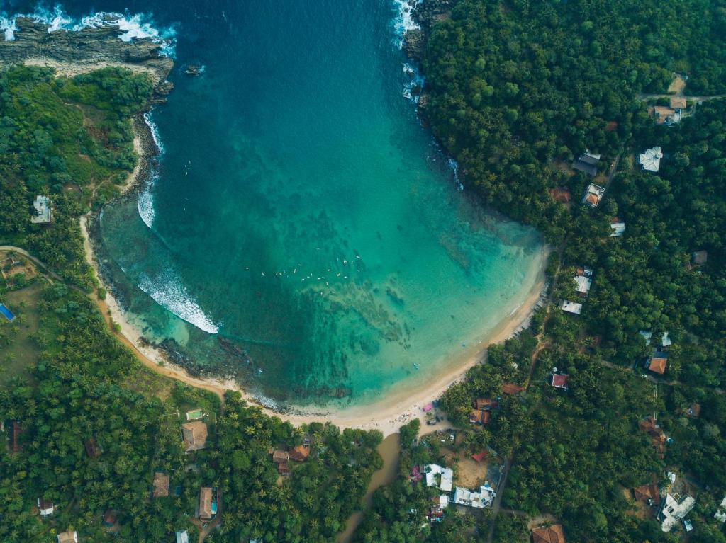 an aerial view of a beach and the ocean at Dots Bay House in Hiriketiya