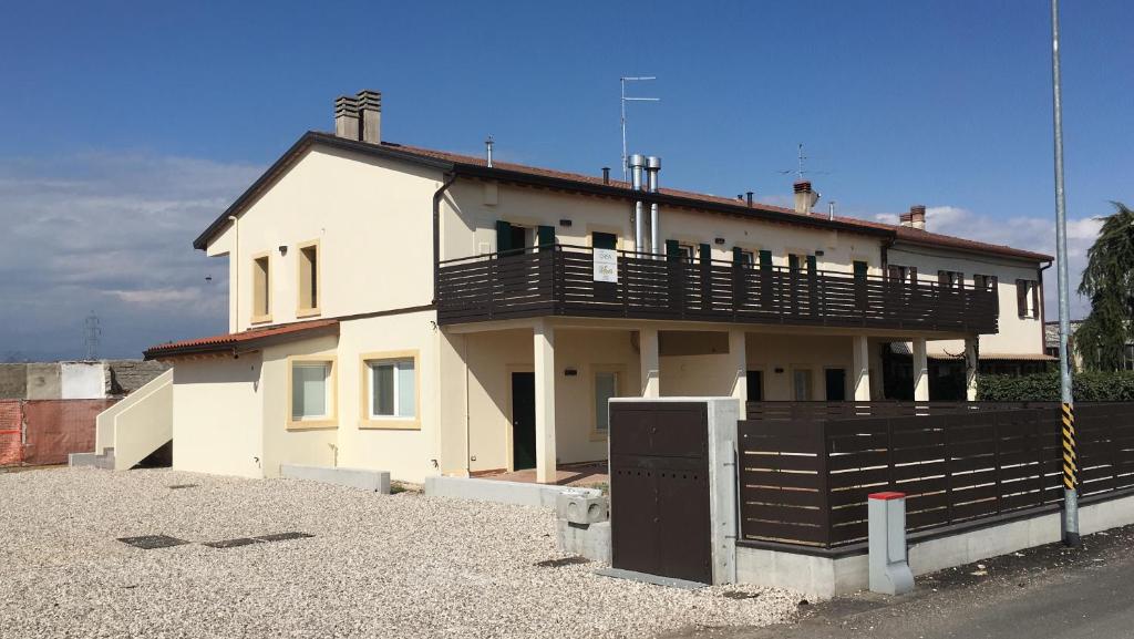 a white house with a balcony on top of it at Gate To Verona in Verona