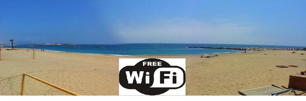 a sign on a beach with the words free wifi at Garrucha Centro y Mar in Garrucha