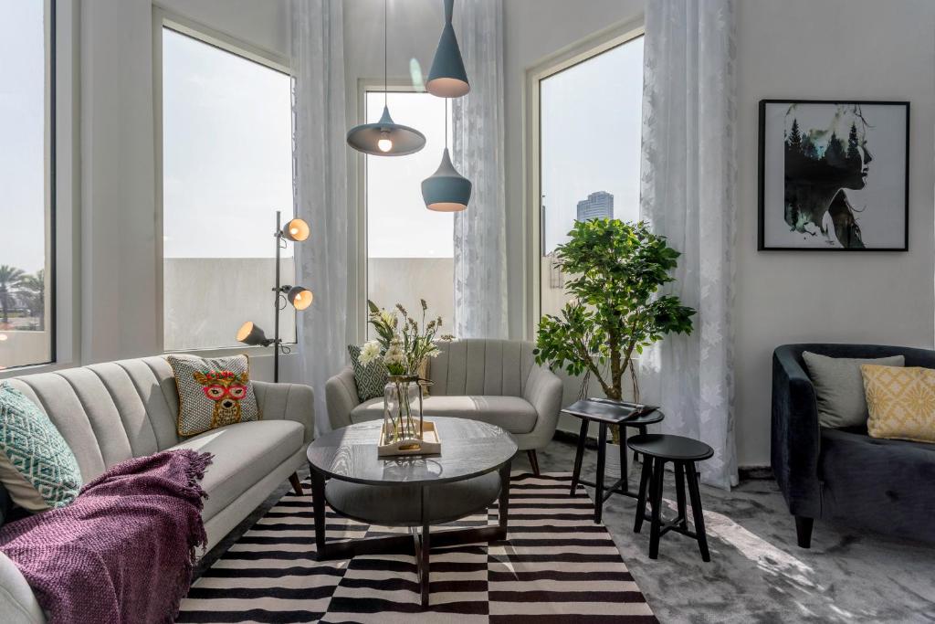 a living room with a couch and a table at One Perfect Stay - Jumeirah Heights in Dubai