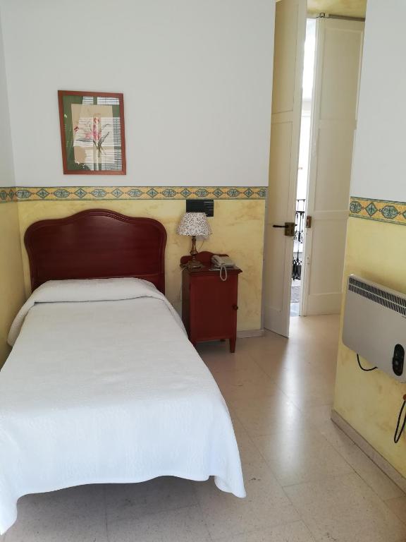 Postel nebo postele na pokoji v ubytování Nuevo Hotel