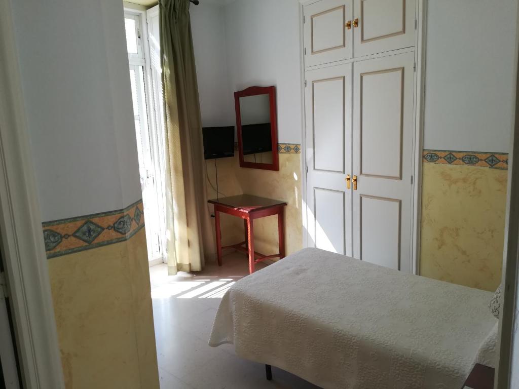 Postel nebo postele na pokoji v ubytování Nuevo Hotel