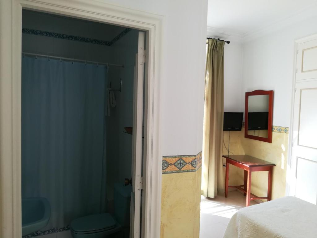 Postel nebo postele na pokoji v ubytování Nuevo Hotel