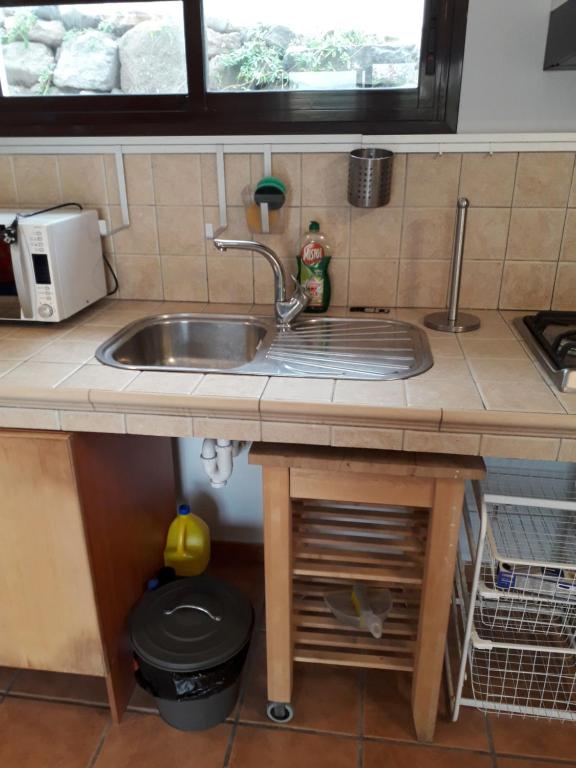 a kitchen counter with a sink and a window at Blue Beach in Famara