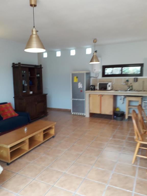 a living room with a couch and a kitchen at Blue Beach in Famara