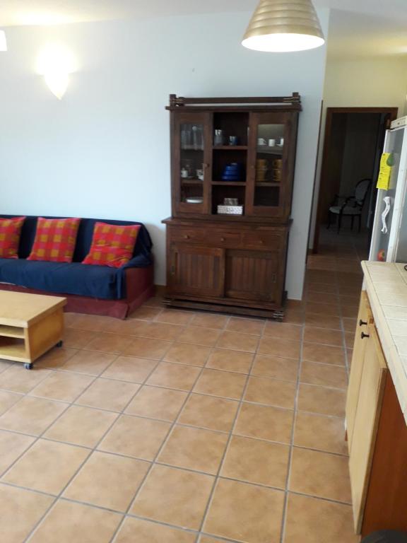 a living room with a blue couch and a cabinet at Blue Beach in Famara