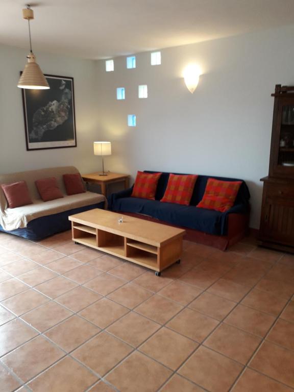 a living room with a couch and a coffee table at Blue Beach in Famara