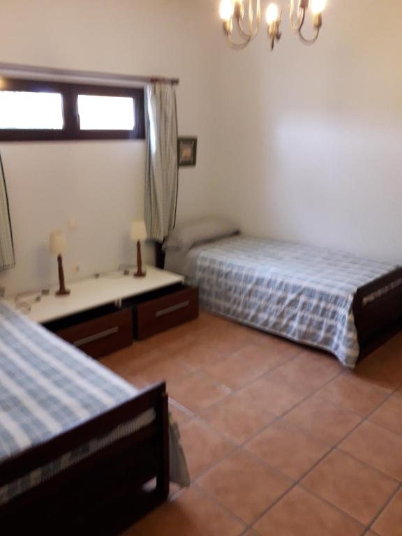 a bedroom with two beds and a window at Blue Beach in Famara