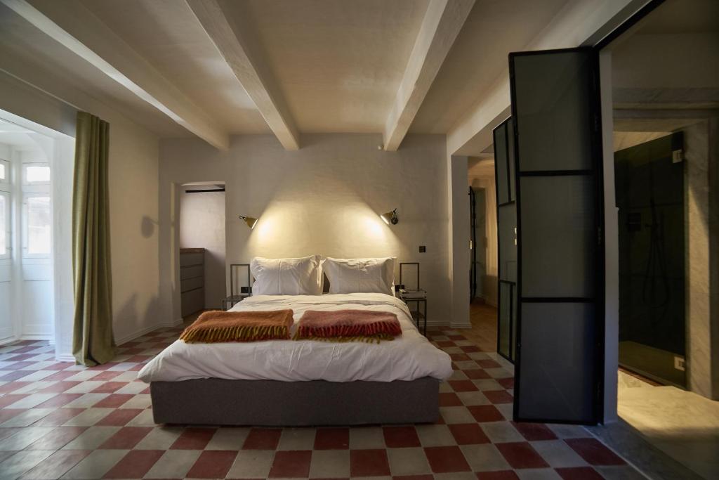 a bedroom with a large bed with a checkered floor at Saint Paul Apartment in Valletta