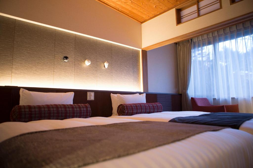 Postel nebo postele na pokoji v ubytování Kamikochi Hotel Shirakabaso