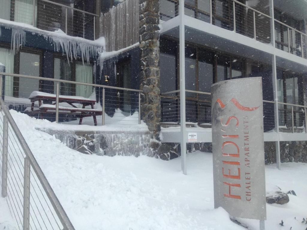a building with a sign in the snow at Snowstay at Heidi’s in Smiggin Holes