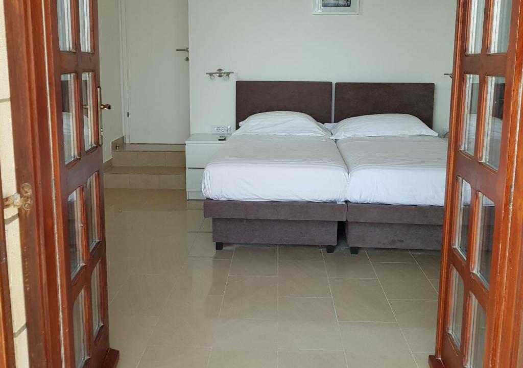 a bedroom with a large bed with white sheets at Old Town & Sea View in Dubrovnik