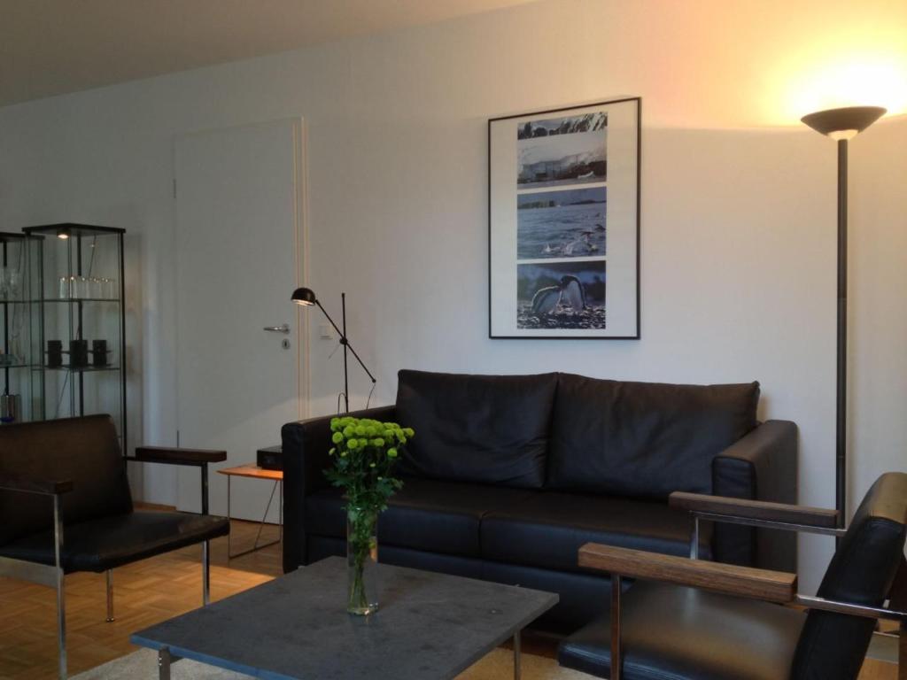 a living room with a couch and a table at Premium Apartment Universities/Arts District in Munich
