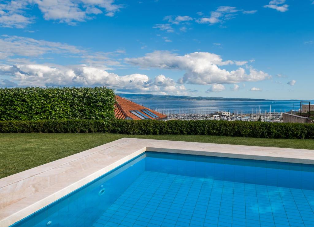 a swimming pool with a view of the ocean at The Whitestone in Split
