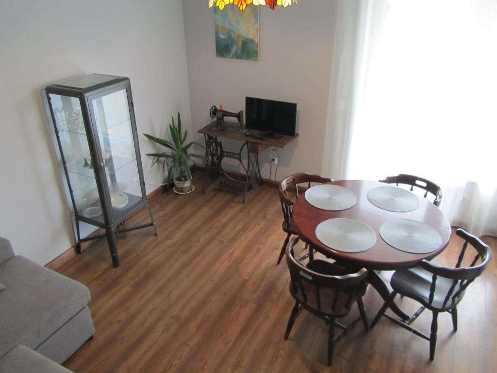 a living room with a dining room table and chairs at Apartament Marycha Sejny in Sejny
