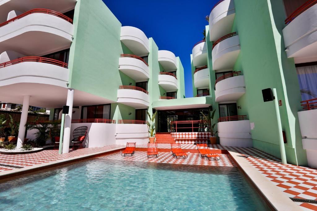 a swimming pool in front of a building at Cubanito Ibiza in San Antonio