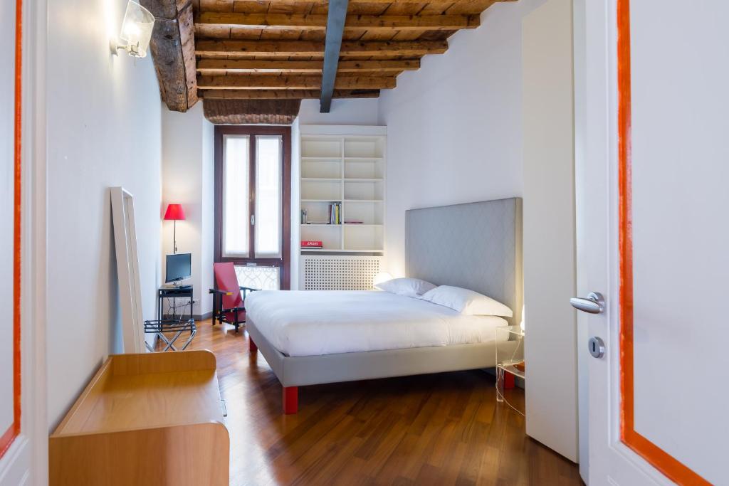 sypialnia z łóżkiem i biurkiem w pokoju w obiekcie Brera 20 w Mediolanie