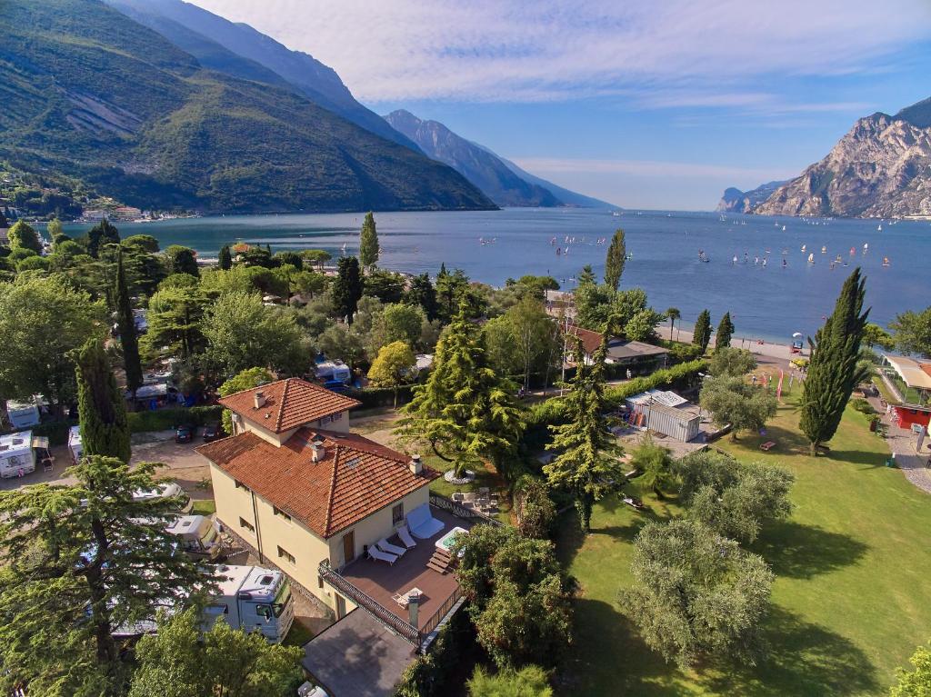 an aerial view of a resort with a lake and mountains at Villa Torbole in Nago-Torbole