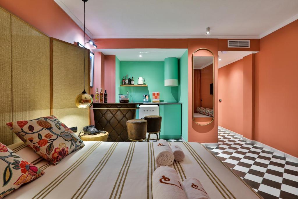 a bedroom with a large bed and a kitchen at Cubanito Ibiza in San Antonio
