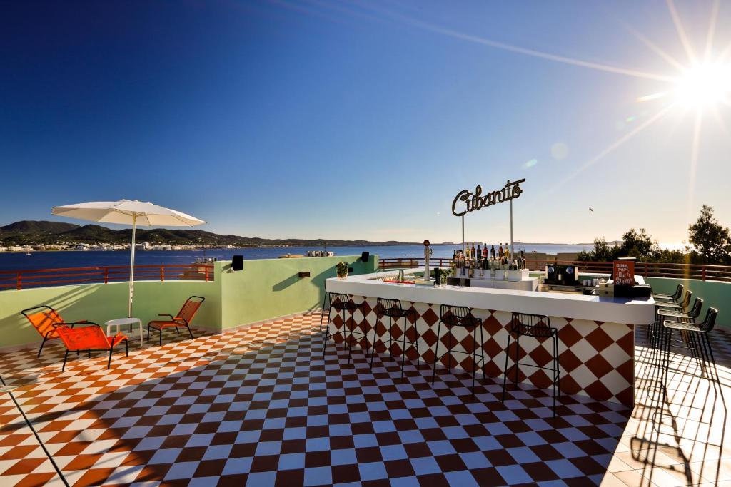 a restaurant with a checkered floor and a bar at Cubanito Ibiza in San Antonio