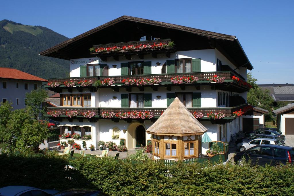 a building with a toy house in front of it at Pension Wörndl in Fuschl am See